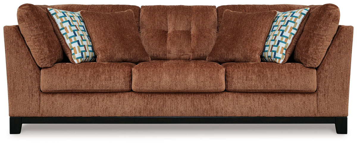 Ashley® Laylabrook plush upholstered sofa with dark wood trim, bold spice color, in a stylish living room setting.
