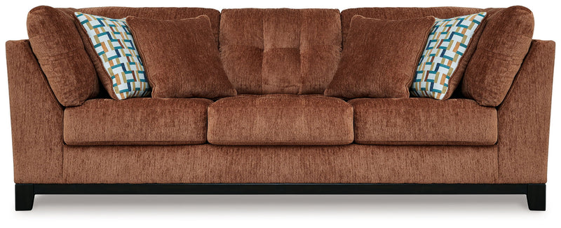 Ashley® Laylabrook plush upholstered sofa with dark wood trim, bold spice color, in a stylish living room setting.