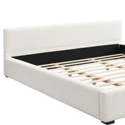 Elegant upholstered bed with wide edge design and soft cushioning, featuring a Noble House frame and plush fabric upholstery.