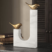 Brass songbird sculpture by Uttermost, detailed figurine showcasing elegant bird design on a sleek base.