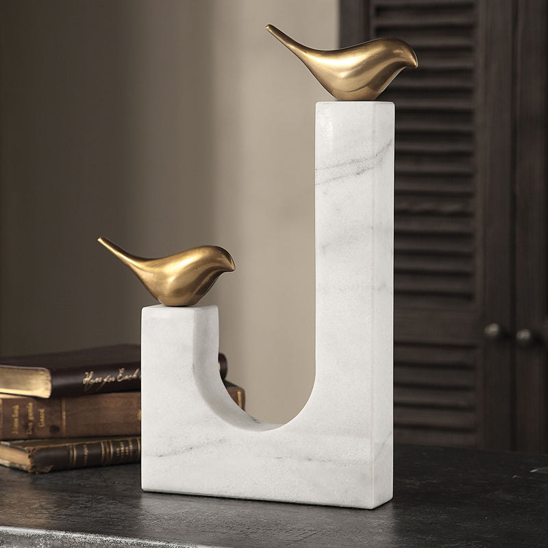 Brass songbird sculpture by Uttermost, detailed figurine showcasing elegant bird design on a sleek base.