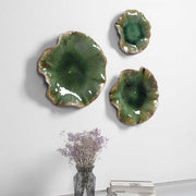 Set of three ceramic wall decor pieces by Uttermost featuring modern abstract designs for stylish interior decoration.