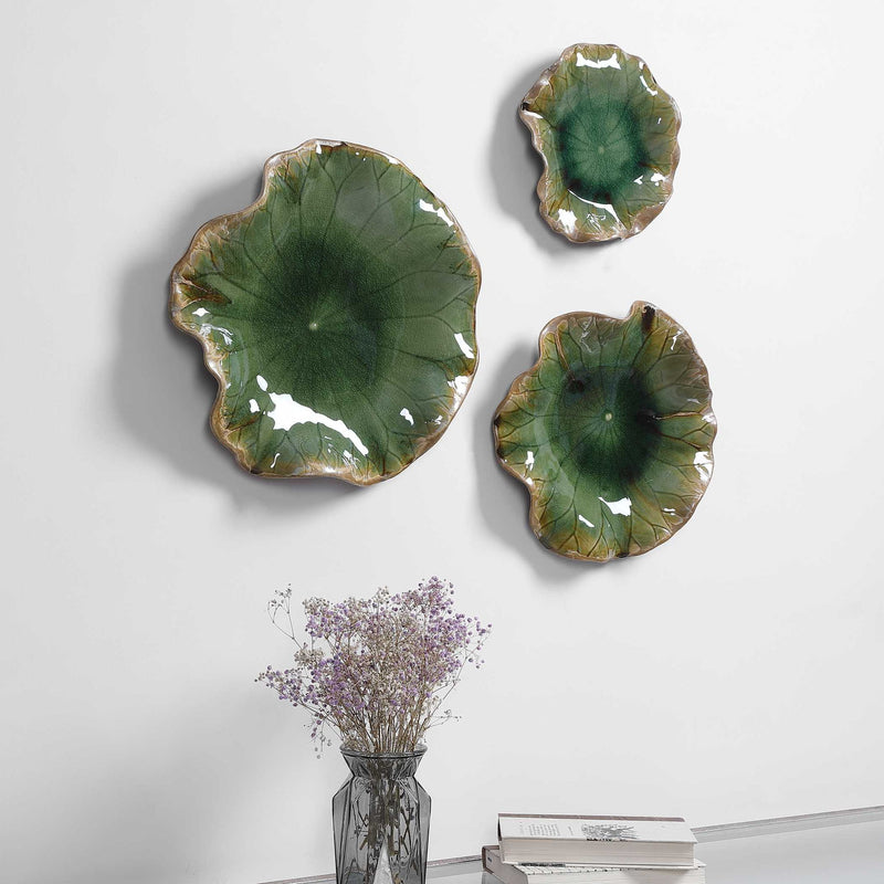 Set of three ceramic wall decor pieces by Uttermost featuring modern abstract designs for stylish interior decoration.