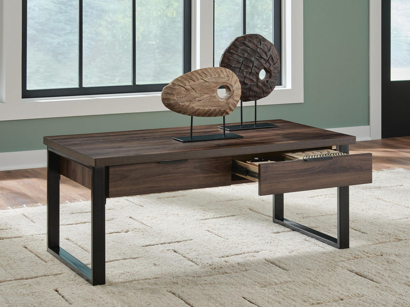 Signature Design by Ashley Wickman Falls rectangular cocktail table with a modern wood finish and sturdy base.