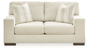 Signature Design by Ashley Maggie living room set includes a stationary chair and matching ottoman in a modern fabric.