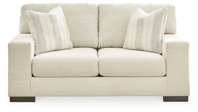 Signature Design by Ashley Maggie living room set includes a stationary chair and matching ottoman in a modern fabric.