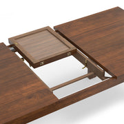 Wilson handcrafted dining table by Simpli-Home with wooden finish, shown with chairs in a modern dining room setting.