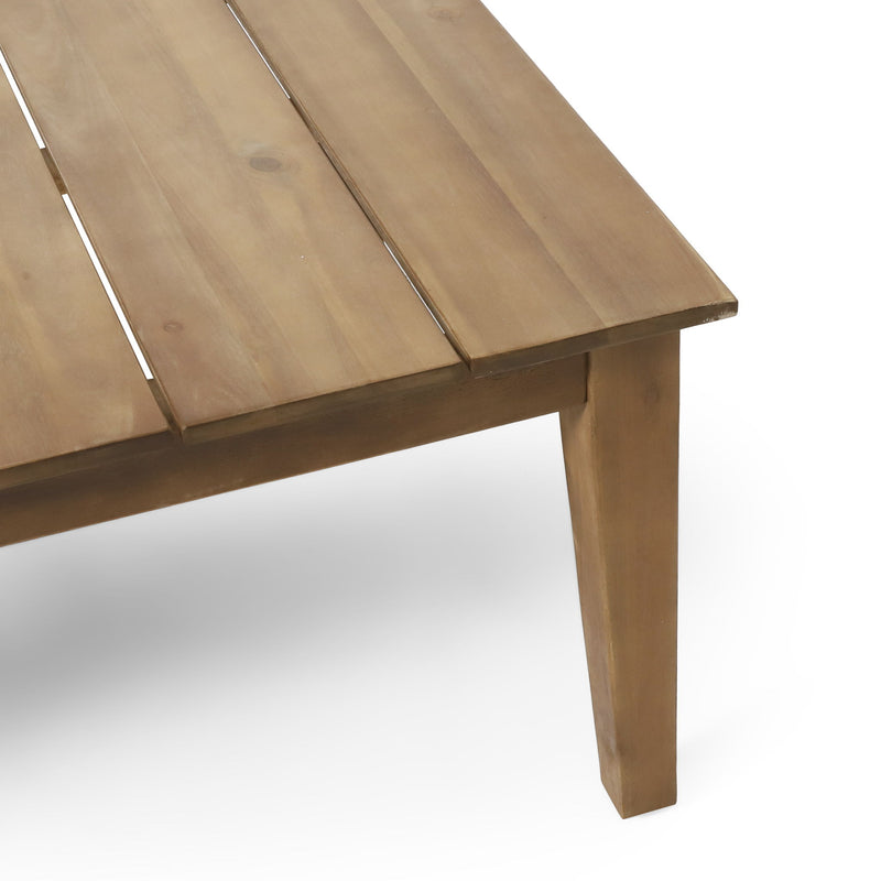 Noble House outdoor coffee table with light brown slat panel top, stylish and durable for patio or garden seating areas.