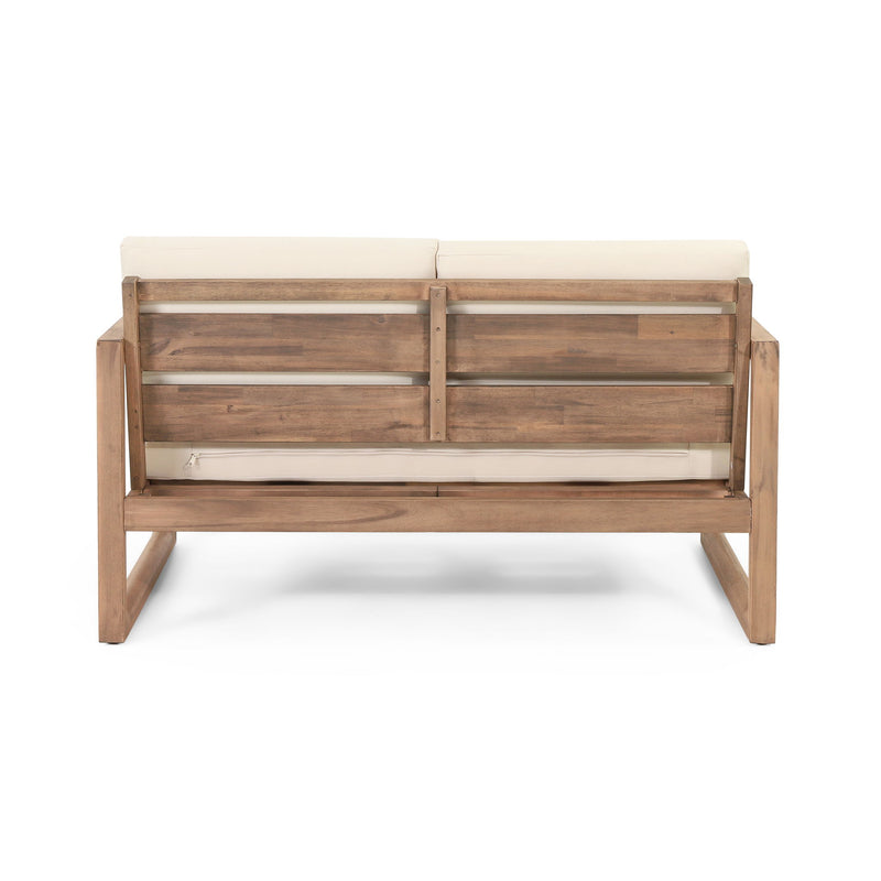 Noble House 4-piece acacia wood outdoor patio furniture set with coffee table, deep seating porch chairs and beige cushions.