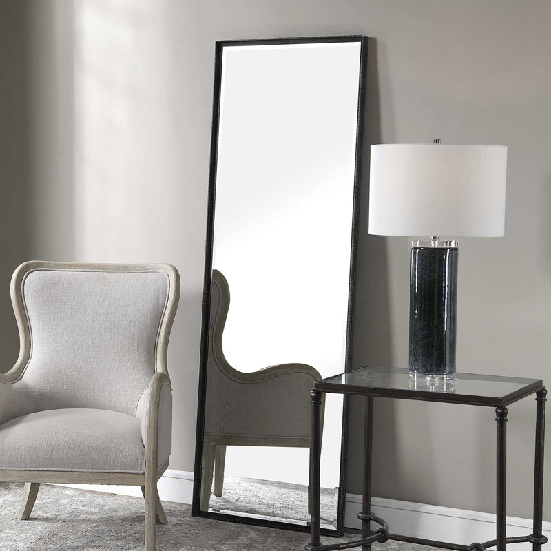 Uttermost Callan Leaner Mirror in black with a sleek, modern frame, standing tall against a neutral background.