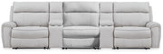 Signature Design by Ashley reclining sectional sofa with plush cushions and modern design, perfect for comfortable living rooms.
