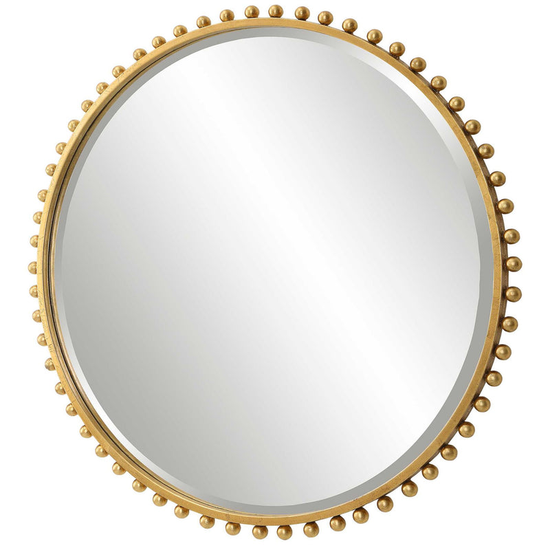 Round iron wall mirror by Uttermost with a sleek, minimalist frame reflecting light and adding modern style to interior spaces