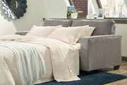 Signature Design by Ashley Altari sleeper sofa with gray fabric, featuring plush cushions and a convertible design for versatile seating.