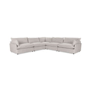 Classic Home Caplan modular sectional sofa with beige upholstery and plush cushions in a modern living room setting.