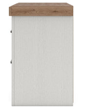 Benchcraft® white and brown two-drawer nightstand with built-in charging station and modern design.