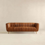 Ashcroft Furniture Ava stationary sofa with gold and tan upholstery, featuring plush cushions and a modern design.