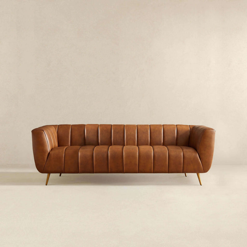Ashcroft Furniture Ava stationary sofa with gold and tan upholstery, featuring plush cushions and a modern design.