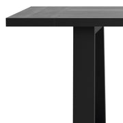 Simpli-Home Whitley dining table with wooden surface and sturdy legs, ideal for modern dining room setups.