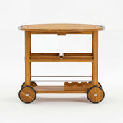 Teak outdoor bar cart with foldable tabletop and removable trays, designed as a versatile storage table for outdoor entertaining.