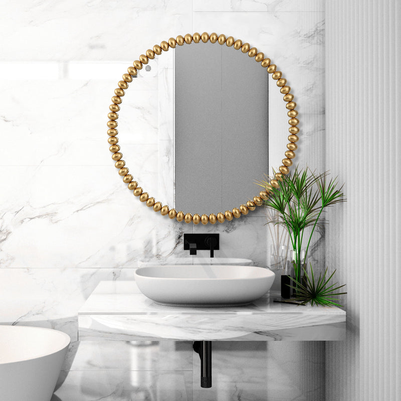 Round gold Byzantine wall mirror by Uttermost with ornate, detailed frame suitable for elegant home decor.