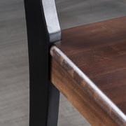 Set of two Noble House Plethora dining chairs with X-shaped backrests, showcasing modern wooden frame and upholstered seats.