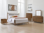 Signature Design by Ashley upholstered bed with padded headboard and sleek frame, showcasing stylish and comfortable bedroom furniture.