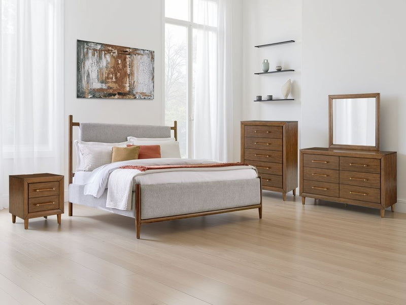Signature Design by Ashley upholstered bed with padded headboard and sleek frame, showcasing stylish and comfortable bedroom furniture.