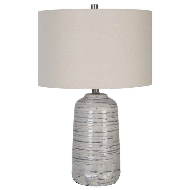 Uttermost Cyclone ivory table lamp with textured ceramic base and fabric shade, ideal for modern and contemporary decor.
