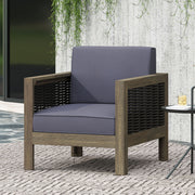 Outdoor acacia wood arm chair with wicker accents by Noble House, showcasing a sturdy frame and stylish woven details.