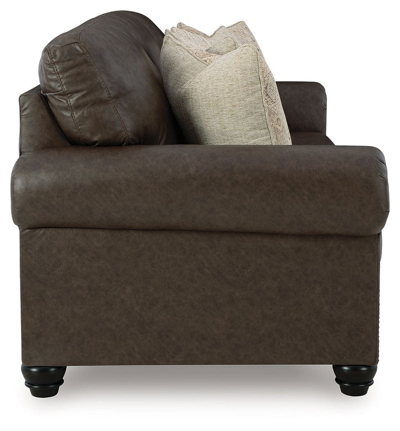 Benchcraft Roxmere living room set featuring a stationary chair and matching ottoman in a cozy, modern design.