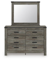 Signature Design by Ashley six-drawer dresser with sleek wood finish and modern hardware, showcasing ample storage space.