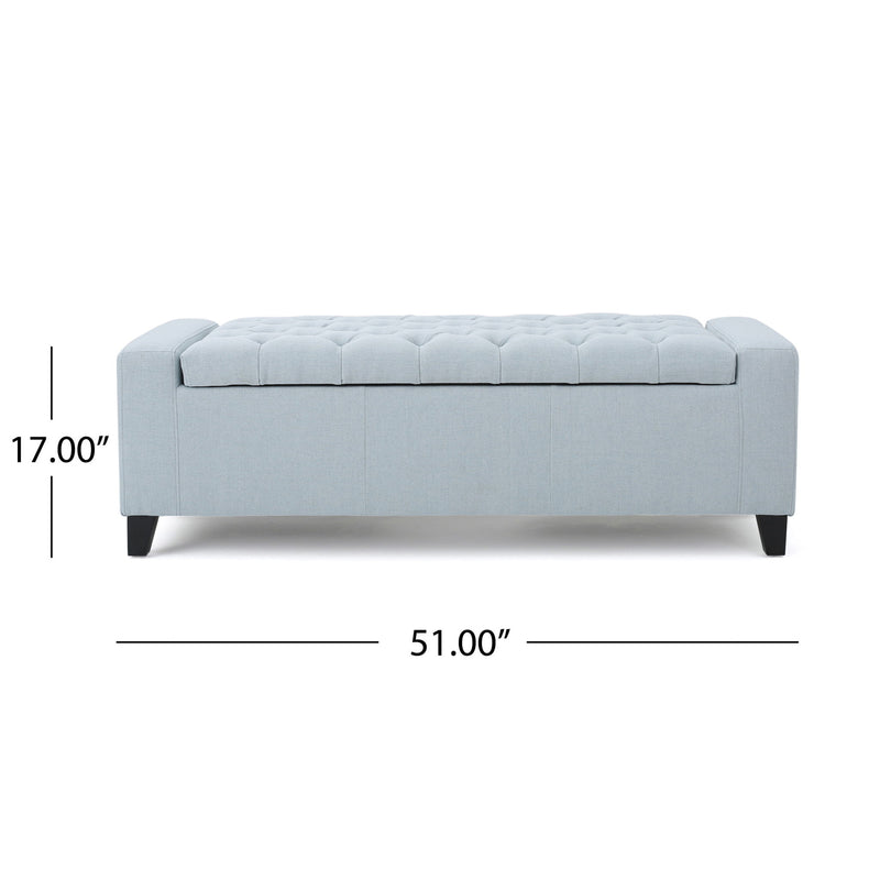 Noble House Guernsey storage ottoman with tufted top, wooden legs, and soft fabric upholstery for versatile living room storage.
