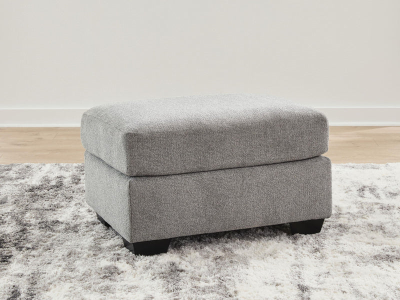 Benchcraft® upholstered ottoman with plush cushioning and fabric upholstery, ideal for living room or seating area.