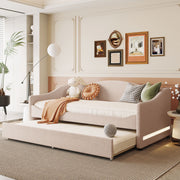 Design upholstered daybed with light-colored fabric and attached trundle bed by Halcyon Home, shown with cushions and bedding.