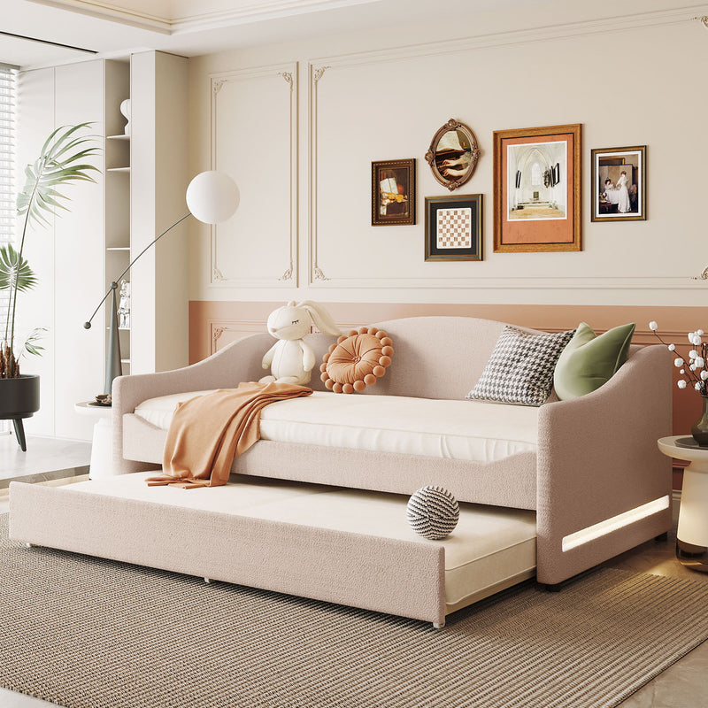 Design upholstered daybed with light-colored fabric and attached trundle bed by Halcyon Home, shown with cushions and bedding.