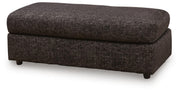 Black oversized accent ottoman from Signature Design by Ashley, featuring a plush fabric surface and modern design.