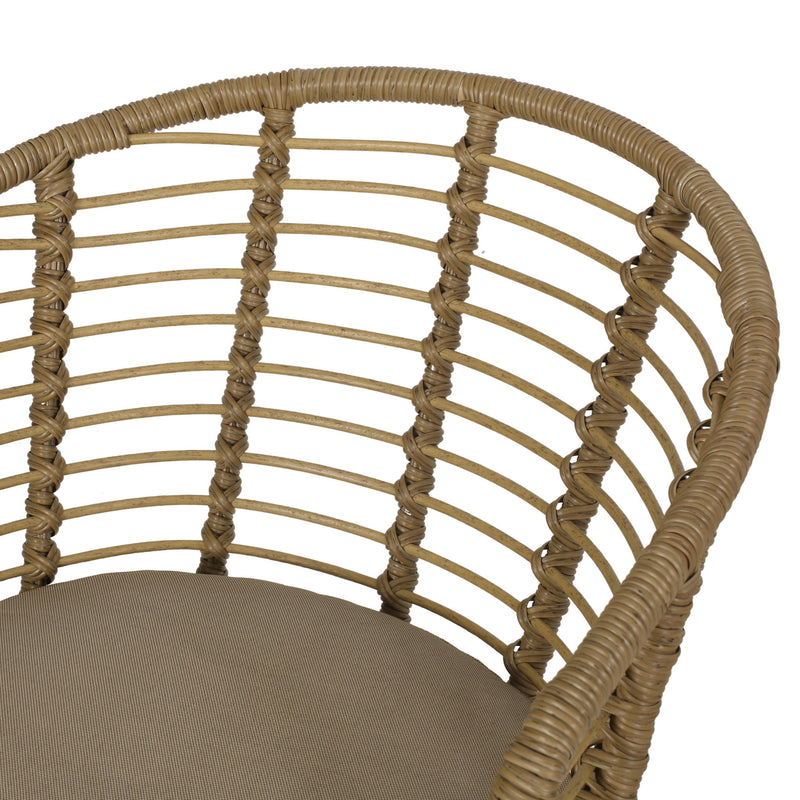 Brown wicker arm chair with beige water-resistant cushions from Noble House, modern design perfect for outdoor or indoor use.