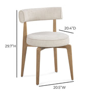 Cream fabric Nikita side dining chair by TOV Furniture featuring a sleek, modern design with a cushioned seat and wooden legs.