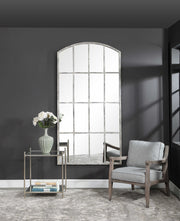Ivory arched wall mirror by Uttermost featuring an elegant curved frame, ideal for enhancing any living space.