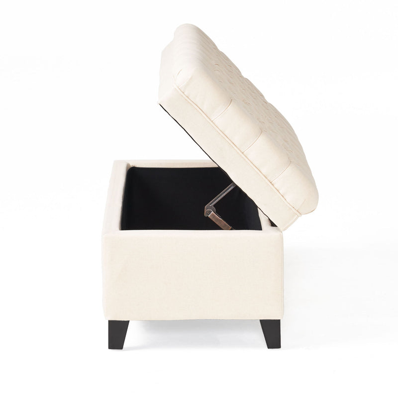 Noble House Juliana storage ottoman with birch legs, upholstered in fabric, showing its cushioned top and wooden legs.