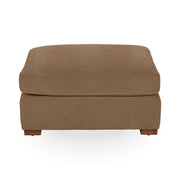 Classic Home Audrey upholstered ottoman with plush fabric and wooden legs, serving as a stylish and functional accent piece.