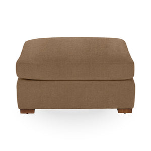 Classic Home Audrey upholstered ottoman with plush fabric and wooden legs, serving as a stylish and functional accent piece.