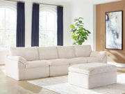 Ivory Fannin 4-piece sectional with ottoman from Signature Design by Ashley®, featuring plush cushions and modern design.
