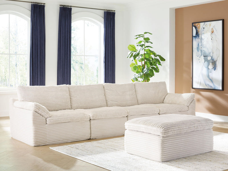 Ivory Fannin 4-piece sectional with ottoman from Signature Design by Ashley®, featuring plush cushions and modern design.