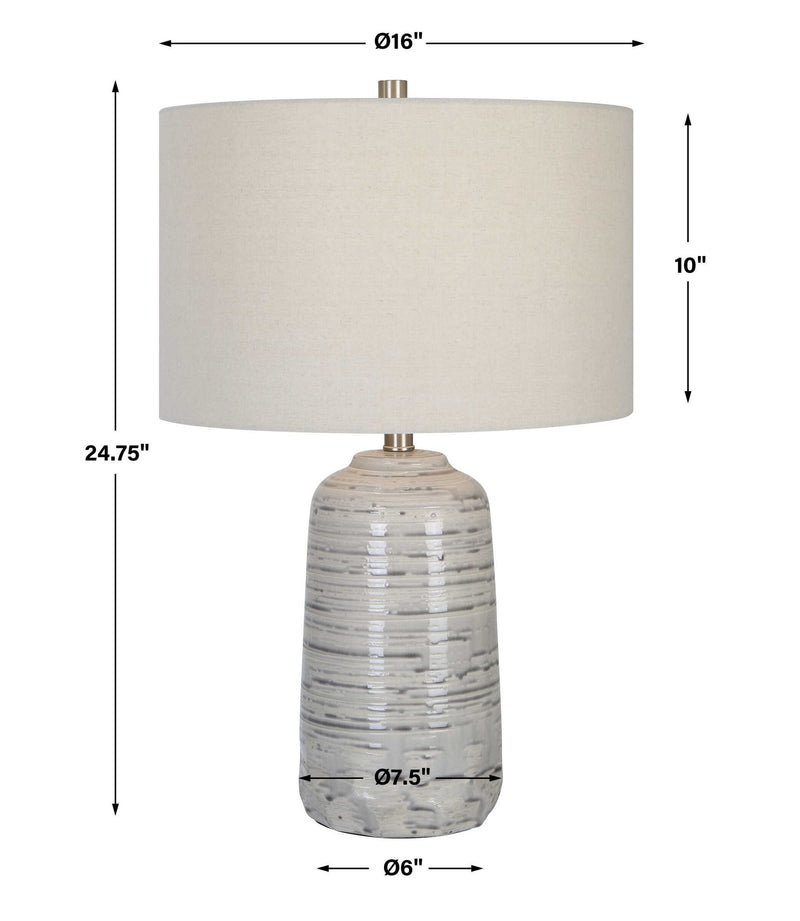 Uttermost Cyclone ivory table lamp featuring a textured ceramic base and fabric shade, ideal for modern or classic decor.