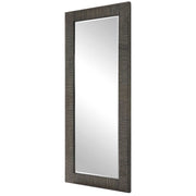 Gray Figaro oversized accent mirror by Uttermost with a bold, modern frame, hanging on a wall in a stylish interior space.