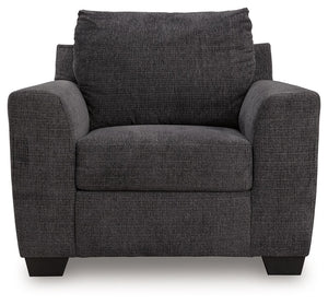 Benchcraft® Loreo arm chair with plush fabric upholstery and modern design, shown in a cozy living room setting.