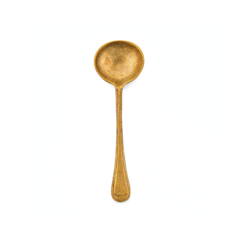 Large brass serving spoon from TOV Furniture's Anuja flatware set, featuring a sleek, polished design for elegant dining.