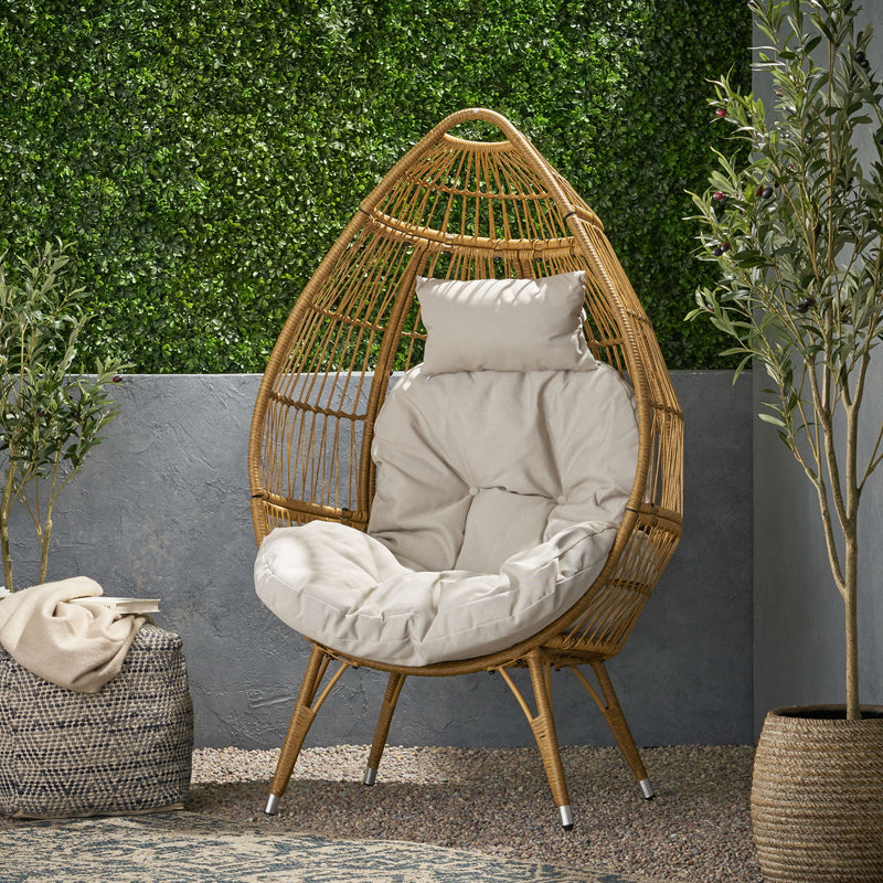 Noble House basket accent chair with teardrop shape and water-resistant cushion in natural finish, perfect for indoor or outdoor use.