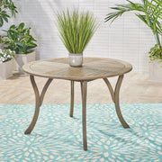 Hermosa outdoor acacia wood dining table with a circular design by Noble House, showcasing sturdy, natural wood surface and outdoor-ready style.